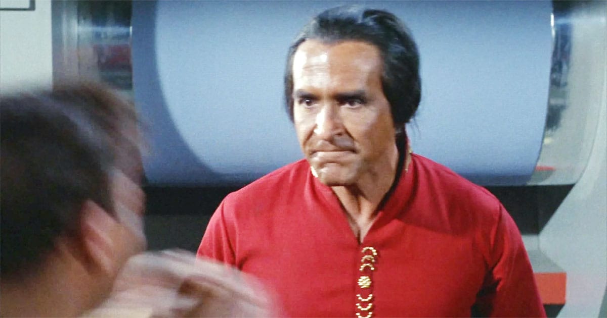 Ricardo Montalbán as Khan Noonien Singh in "Space Seed," wearing a golden tunic with an intense expression, exuding confidence and intelligence.