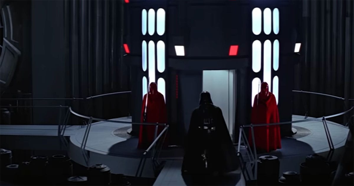 Screen capture of Darth Vader and to red Imperial Guards from the movie Return of the Jedi.