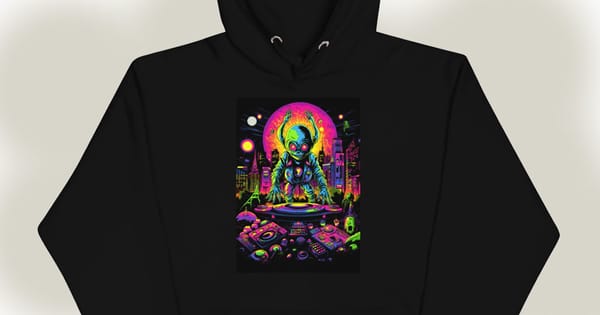 Black hoodie featuring a neon-colored alien DJ spinning tracks in a futuristic cityscape with a glowing pink moon.